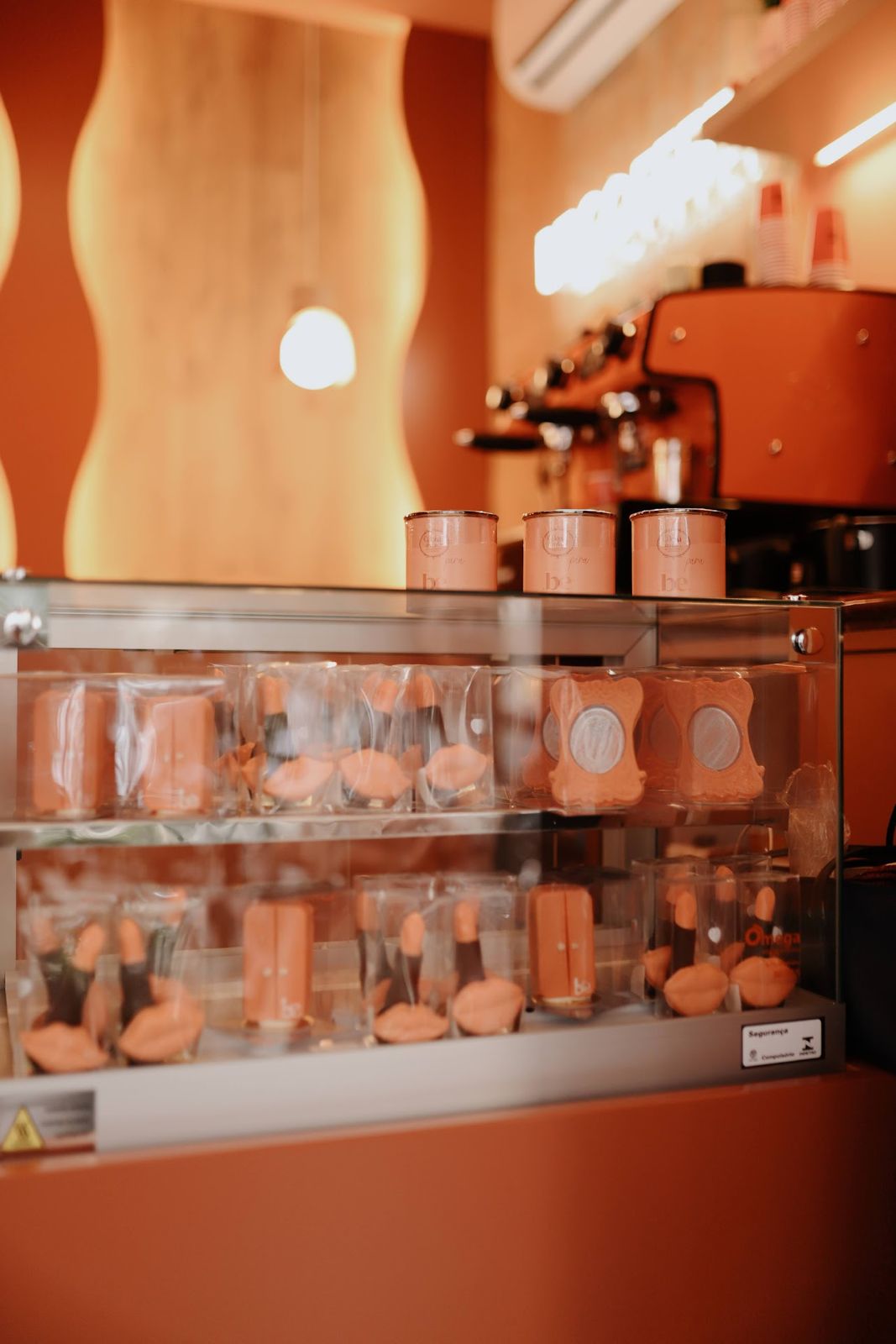 Vitrine de produtos em tons terracota na loja Belong Be